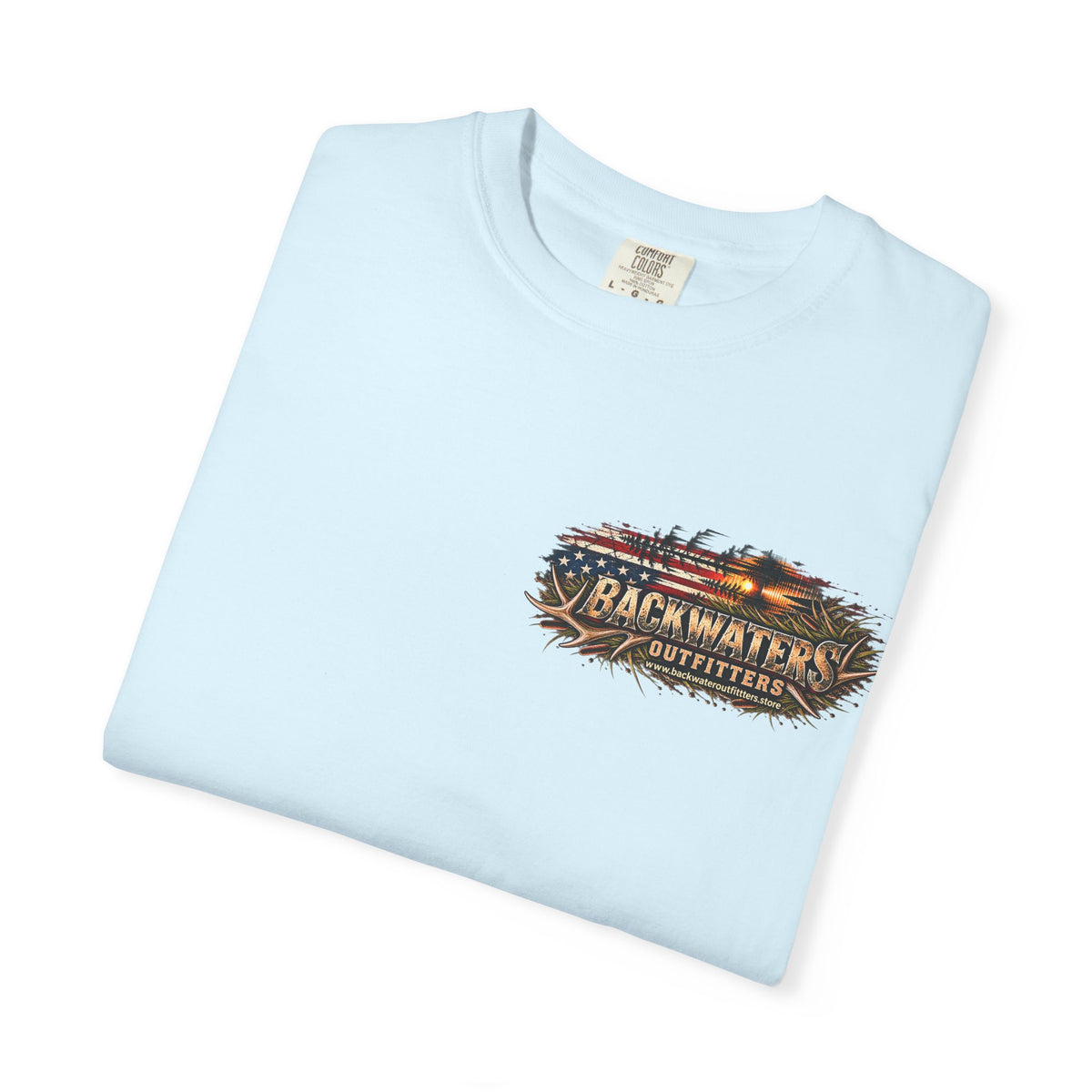 A light blue folded crewneck t-shirt with a 'Backwaters Outfitters' graphic printed on the left chest, displayed on a clean white background.